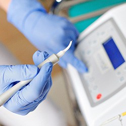 Dental team member preparing to use soft tissue laser