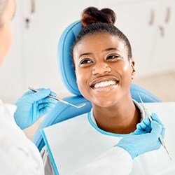 Happy patient looking up at her dentist