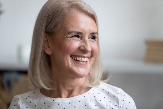 woman smiling after getting dental implants